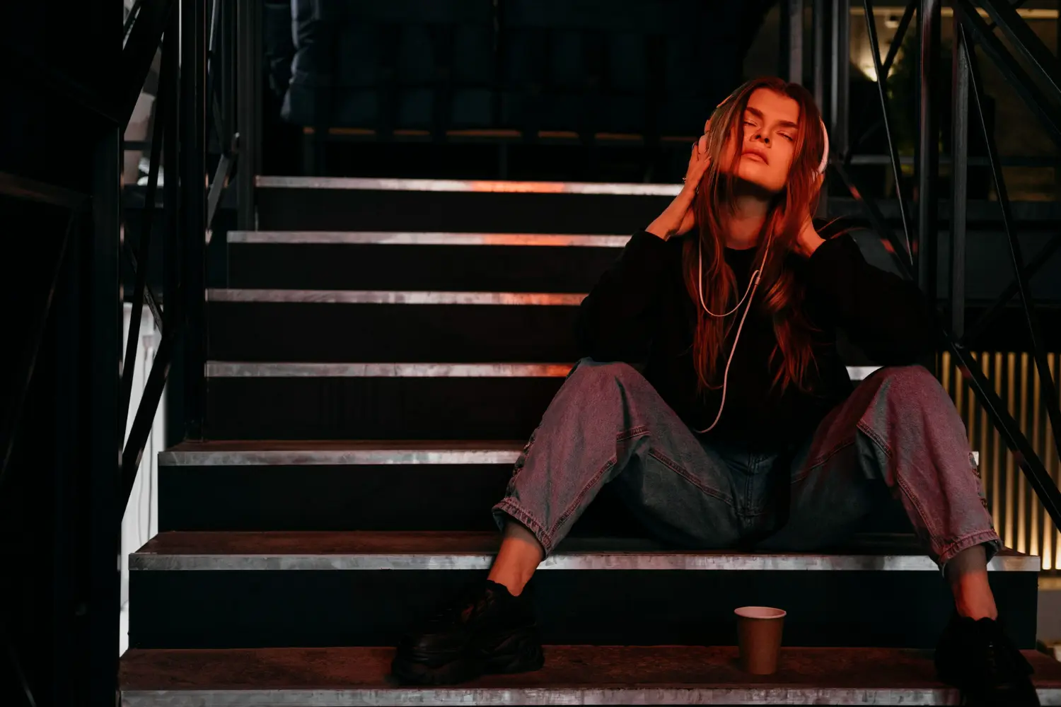 chica triste sentada en una escalera