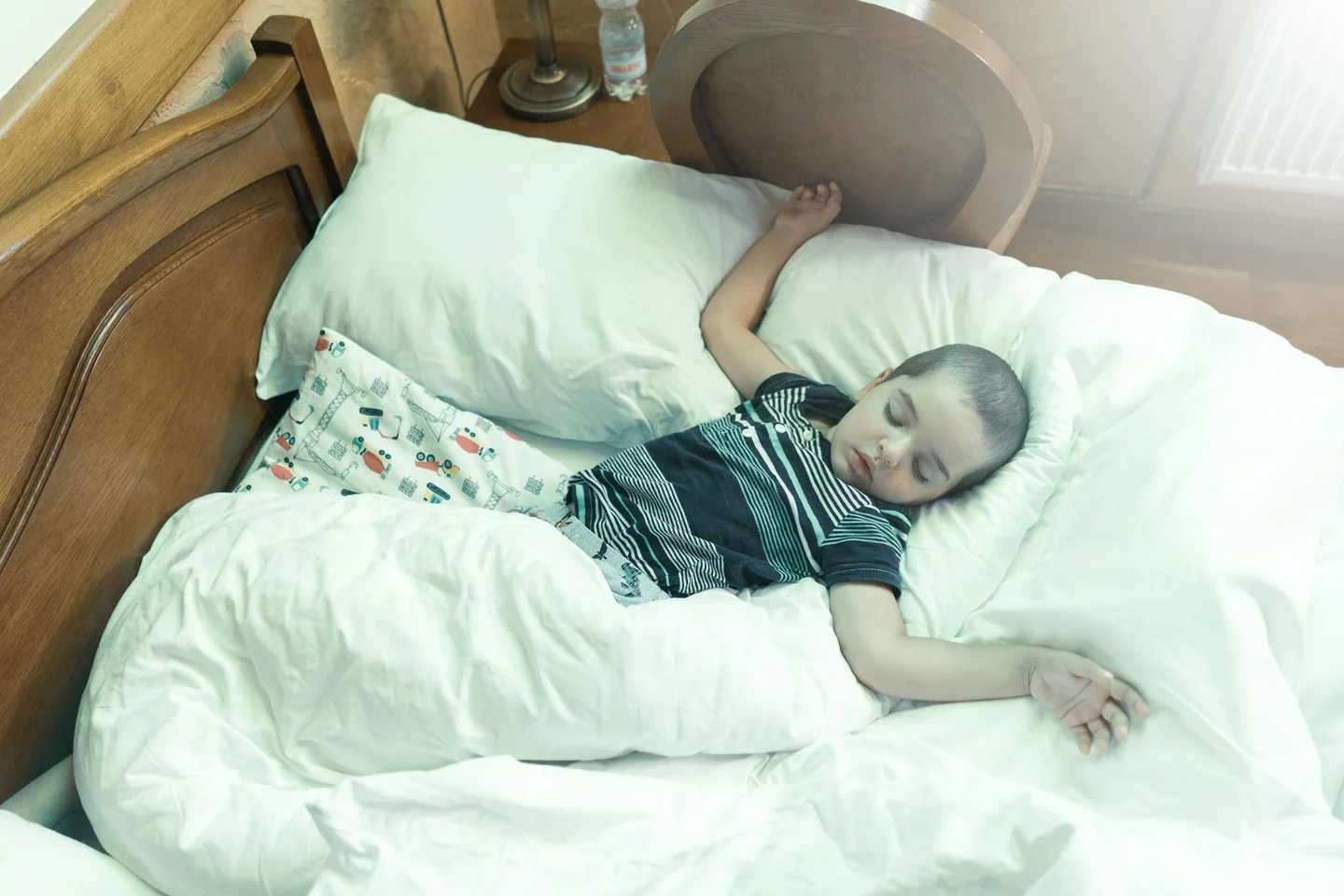 Imagen relacionada con porque un niño se orina en la cama psicología, mostrando a un niño dormido en su cama por la noche