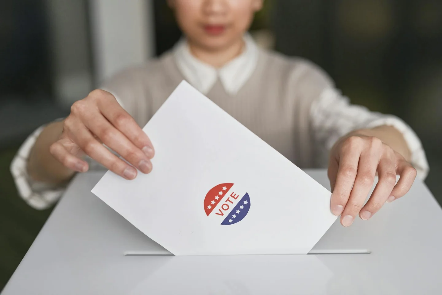 Persona votando en una urna para ilustrar porque no es obligatorio votar en españa y la libertad de participación electoral