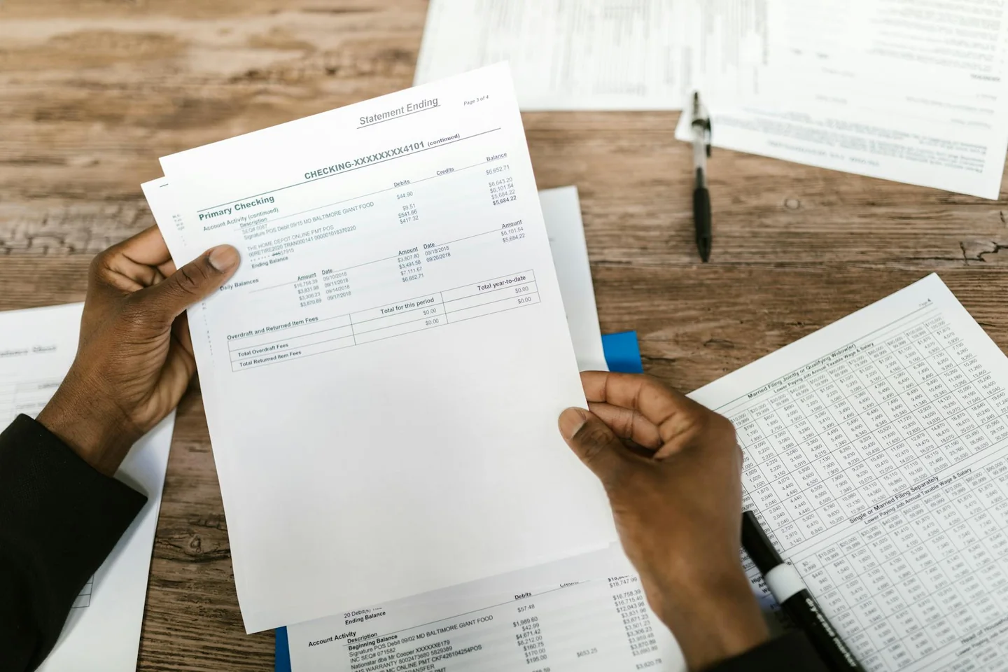 tax accountant reviewing documentos para explicar porque este año me devuelven menos en la declaración