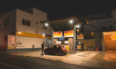 Imagen de una persona repostando un coche para ilustrar por qué no se puede usar el móvil en una gasolinera.