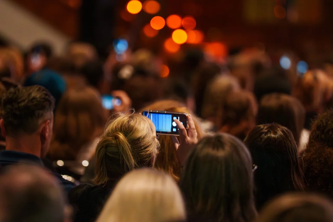 Una persona muestra su entrada digital tras acceder a una preventa de entradas
