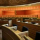 Sala preparada para una Comisión de investigación parlamentaria, con micrófonos y documentos sobre las mesas
