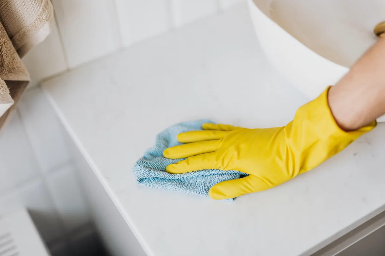 Limpieza del cristal para quitar cal de la mampara de ducha con un paño suave