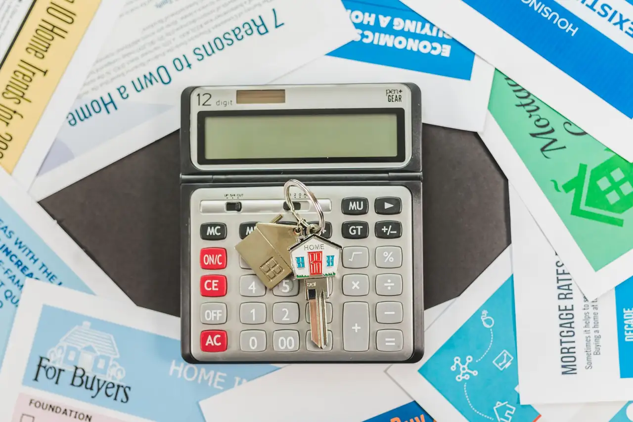 Documentos hipotecarios, calculadora y llaves de una vivienda para analizar una carencia hipotecaria