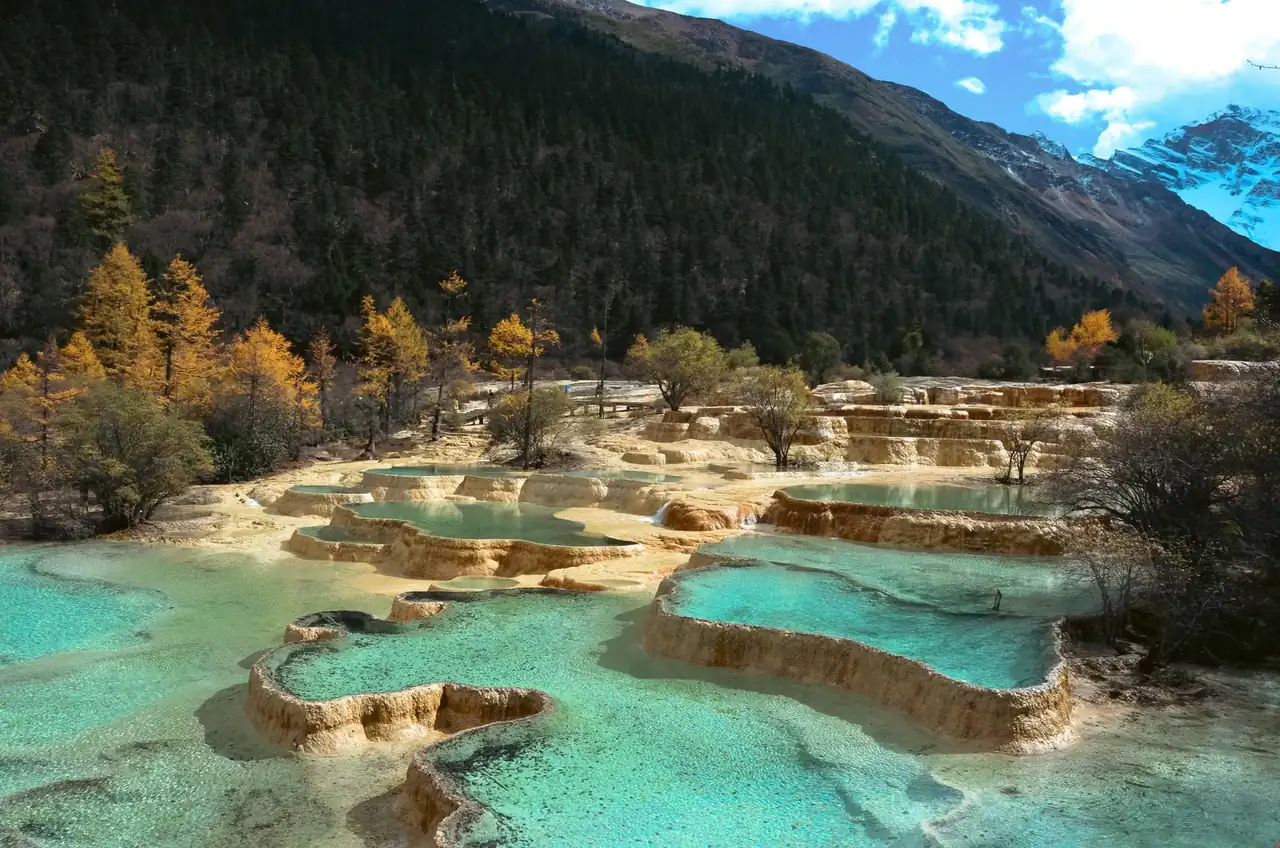 Piscina termal entre montañas que ilustra una escapada a balnearios de España en otoño